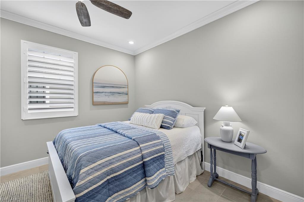 2319 Sawyers Hill Road, Unit 705 Naples, FL 34102 - Photo 20 of 29 Bedroom featuring crown molding, a ceiling fan, recessed lighting, and light tile patterned floors