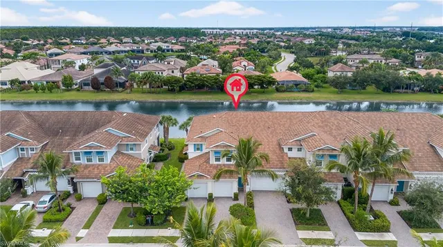 an aerial view of a house with outdoor space and lake view