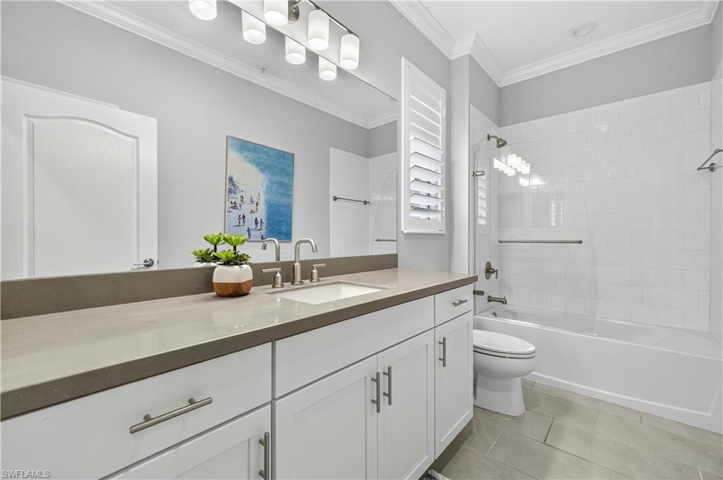 2319 Sawyers Hill Road, Unit 705 Naples, FL 34102 - Photo 22 of 29 Bathroom featuring shower / tub combination, vanity, light tile patterned floors, and ornamental molding