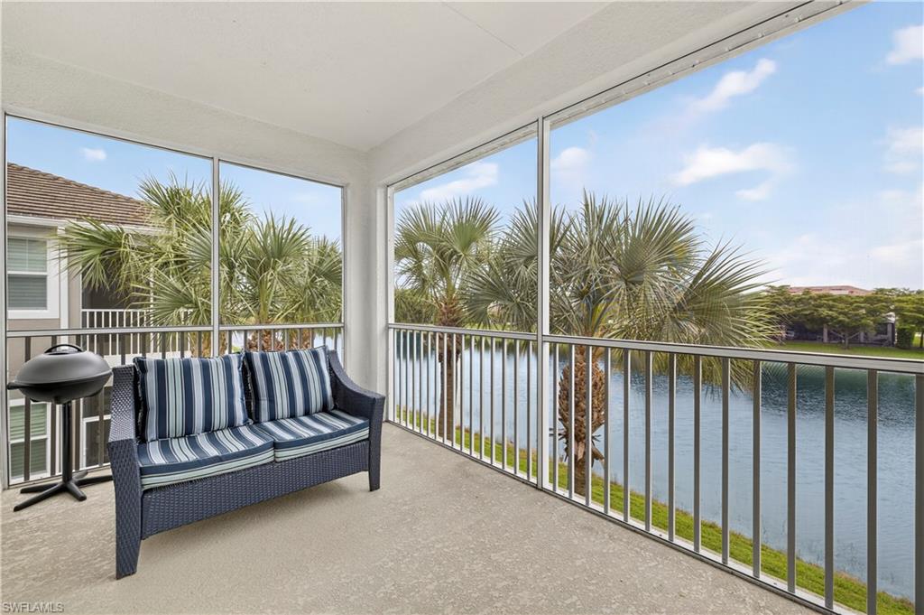 2319 Sawyers Hill Road, Unit 705 Naples, FL 34102 - Photo 25 of 29 Sunroom / solarium with a water view and carpet floors