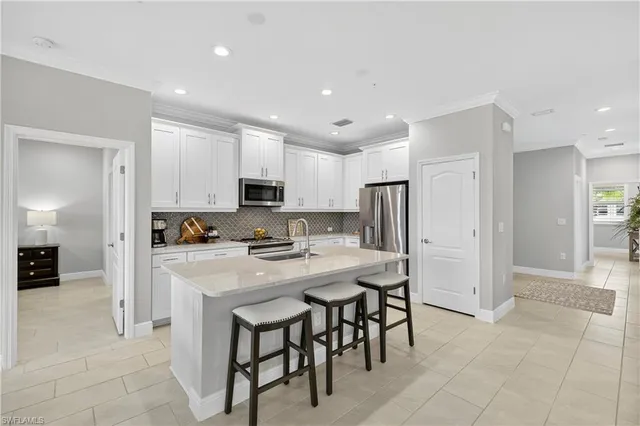 a kitchen with stainless steel appliances a refrigerator and a stove top oven