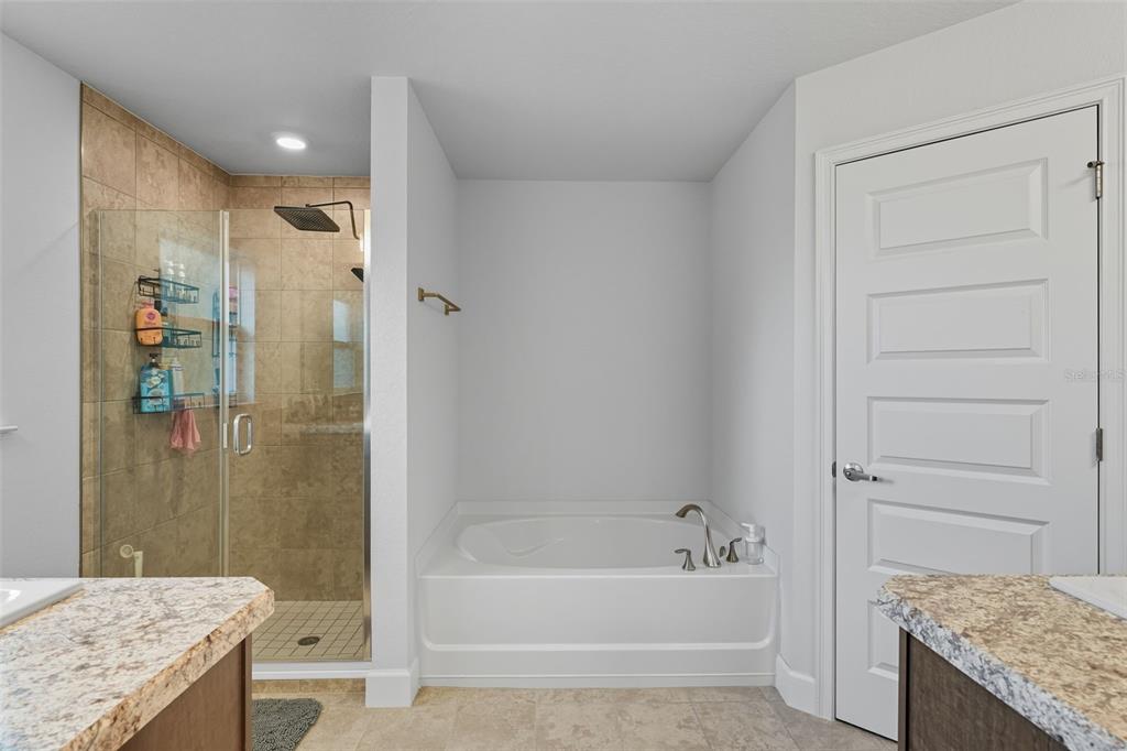 463 Trafalgar Lane Spring Hill, FL 34606 - Photo 22 of 36 a bathroom with a granite countertop sink a toilet and shower