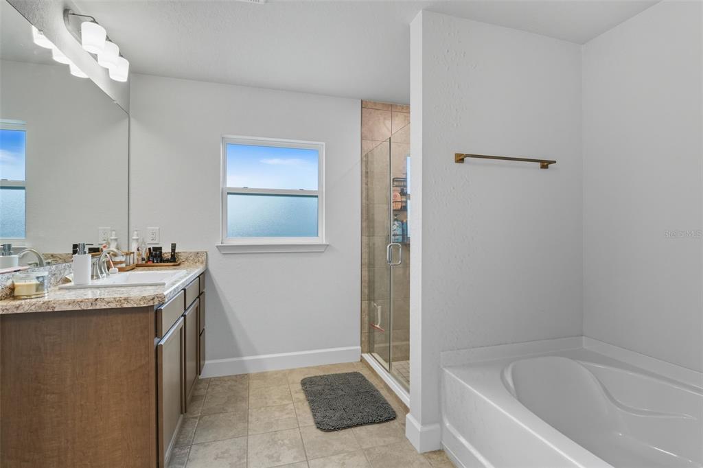 463 Trafalgar Lane Spring Hill, FL 34606 - Photo 23 of 36 a bathroom with a granite countertop sink a toilet and shower