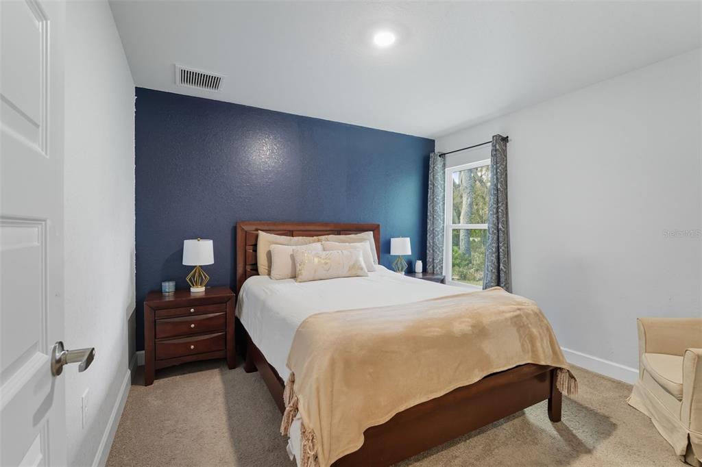 463 Trafalgar Lane Spring Hill, FL 34606 - Photo 25 of 36 a bedroom with a bed and a night stand