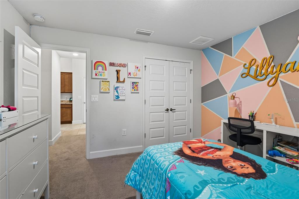 463 Trafalgar Lane Spring Hill, FL 34606 - Photo 32 of 36 a bedroom with a bed and a book shelf