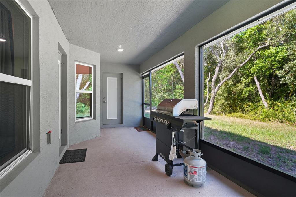 463 Trafalgar Lane Spring Hill, FL 34606 - Photo 33 of 36 a view of a room with gym equipment and large windows