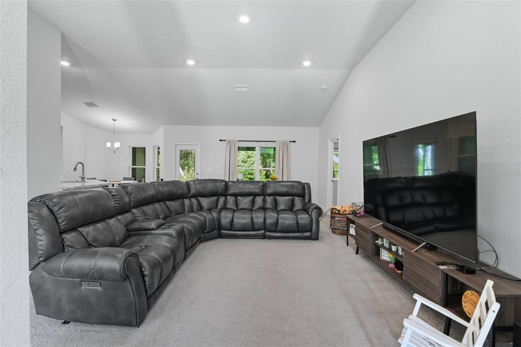 463 Trafalgar Lane Spring Hill, FL 34606 - Photo 8 of 36 a living room with furniture and a flat screen tv
