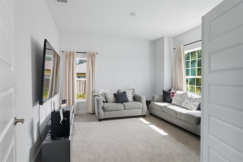 463 Trafalgar Lane Spring Hill, FL 34606 - Photo 9 of 36 a living room with furniture and a flat screen tv