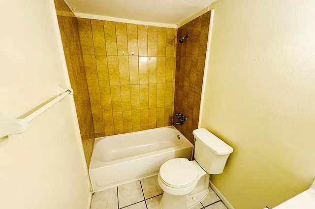 a bathroom with a toilet and shower