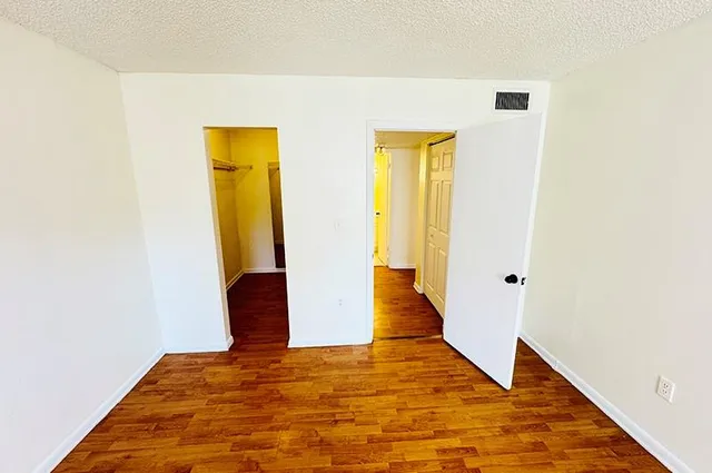 a view of a room with wooden floor