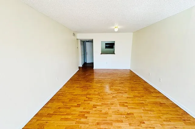 a view of hallway with wooden floor