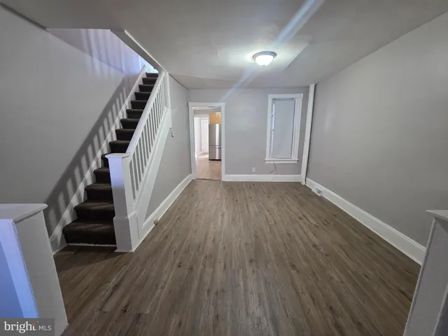 wooden floor in an empty room with a fireplace
