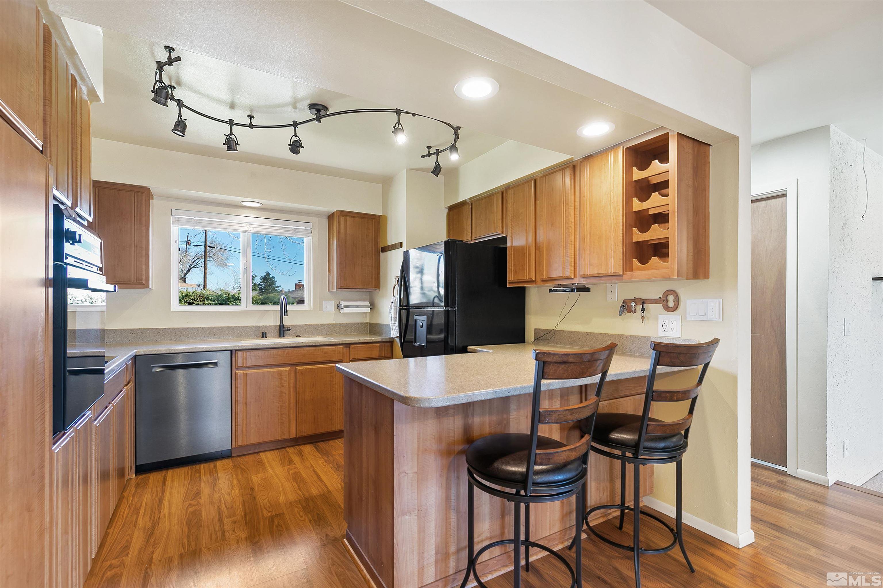 420 Tarn Way Reno, NV 89503 - Photo 10 of 35 a large kitchen with kitchen island granite countertop a sink and cabinets