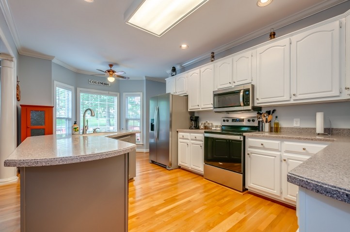 1169 Rip Steele Road Columbia, TN 38401 - Photo 13 of 42 a open kitchen with granite countertop a sink dishwasher stove top oven and cabinets with wooden floor