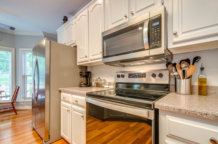 1169 Rip Steele Road Columbia, TN 38401 - Photo 15 of 42 a kitchen with stainless steel appliances granite countertop a stove and a microwave