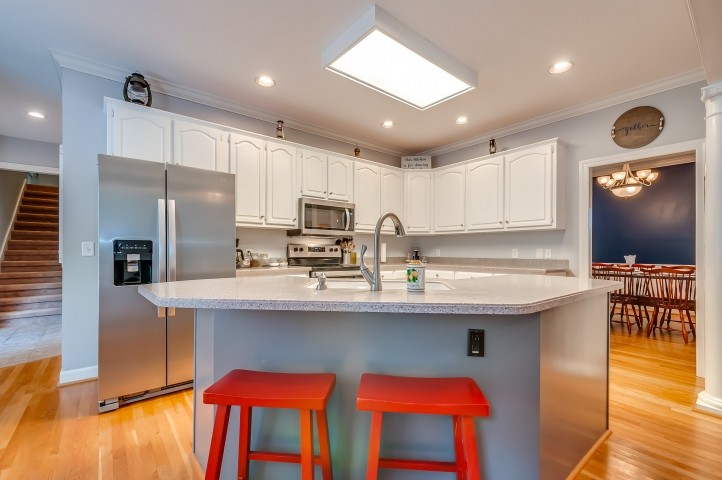 1169 Rip Steele Road Columbia, TN 38401 - Photo 16 of 42 a kitchen with stainless steel appliances granite countertop a sink a stove a refrigerator cabinets and chairs