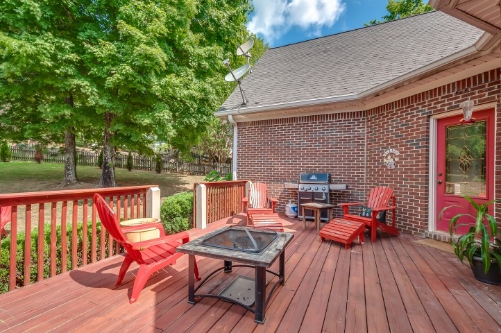 1169 Rip Steele Road Columbia, TN 38401 - Photo 37 of 42 a backyard of a house with wooden floor outdoor seating and yard in the back