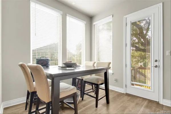 a view of a dining room with furniture and windows