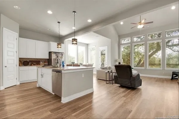 a kitchen with a refrigerator and a stove top oven