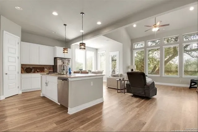 a kitchen with a refrigerator and a stove top oven