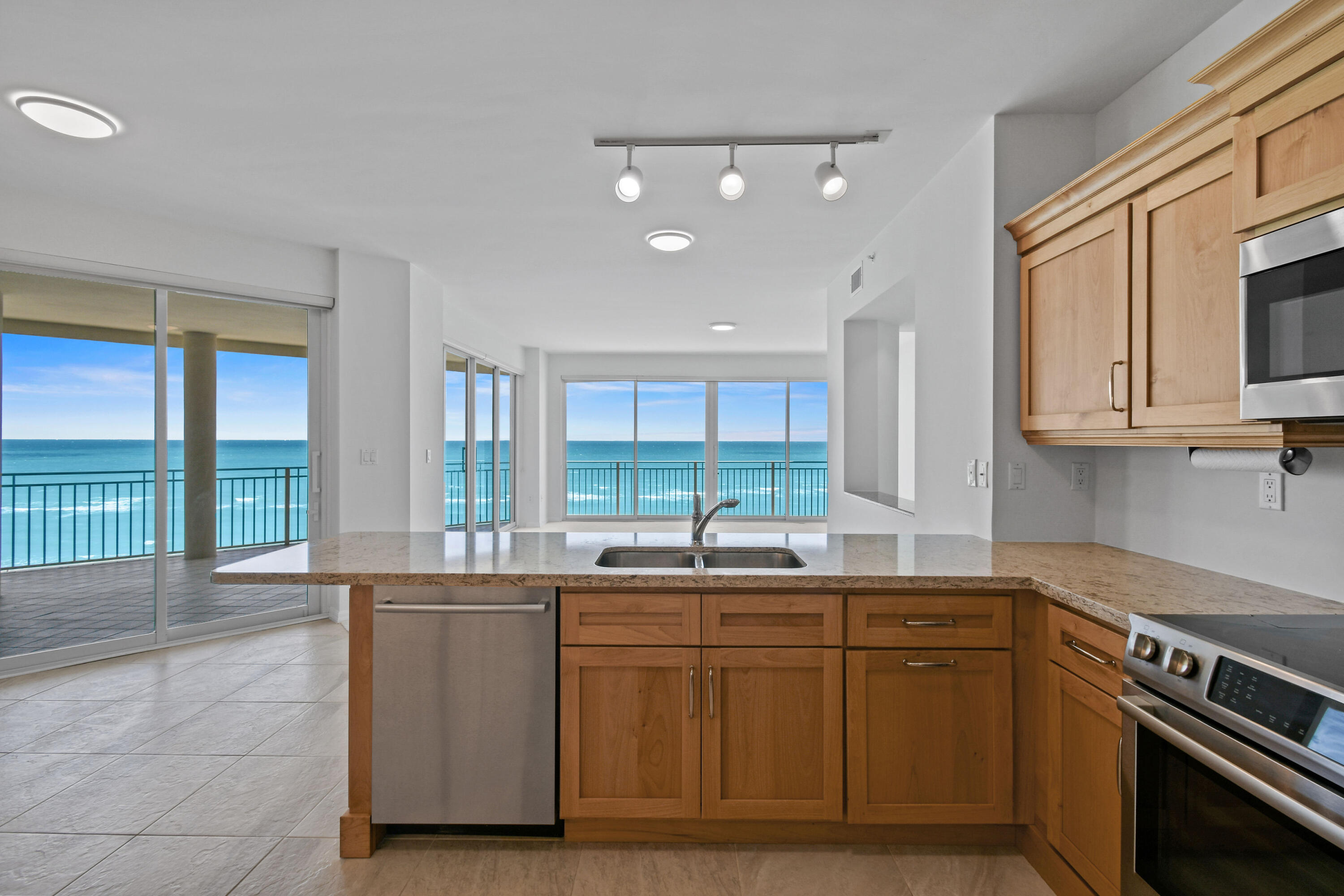 1660 Florida A1A, Unit 352 Jupiter, FL 33477 - Photo 11 of 36 a kitchen with a sink stove and cabinets