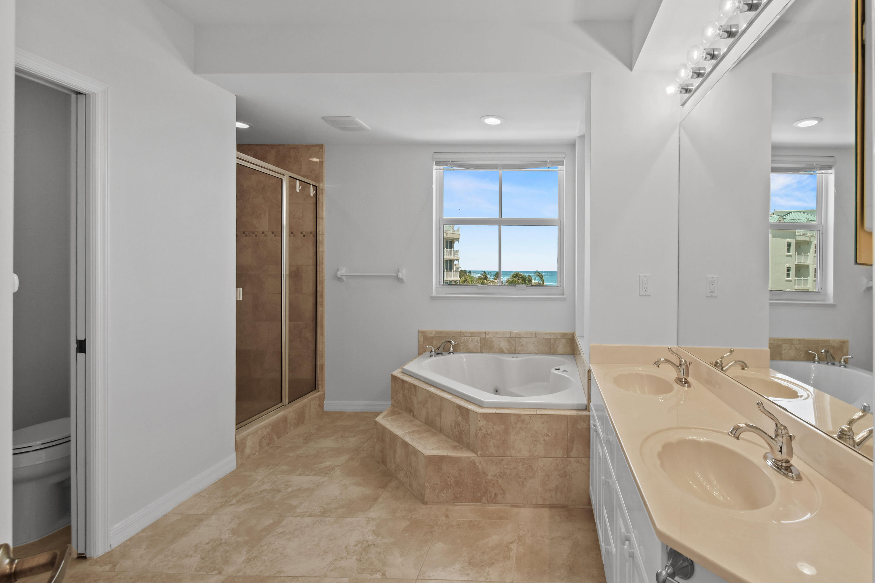 1660 Florida A1A, Unit 352 Jupiter, FL 33477 - Photo 22 of 36 a bathroom with a tub a sink and a window