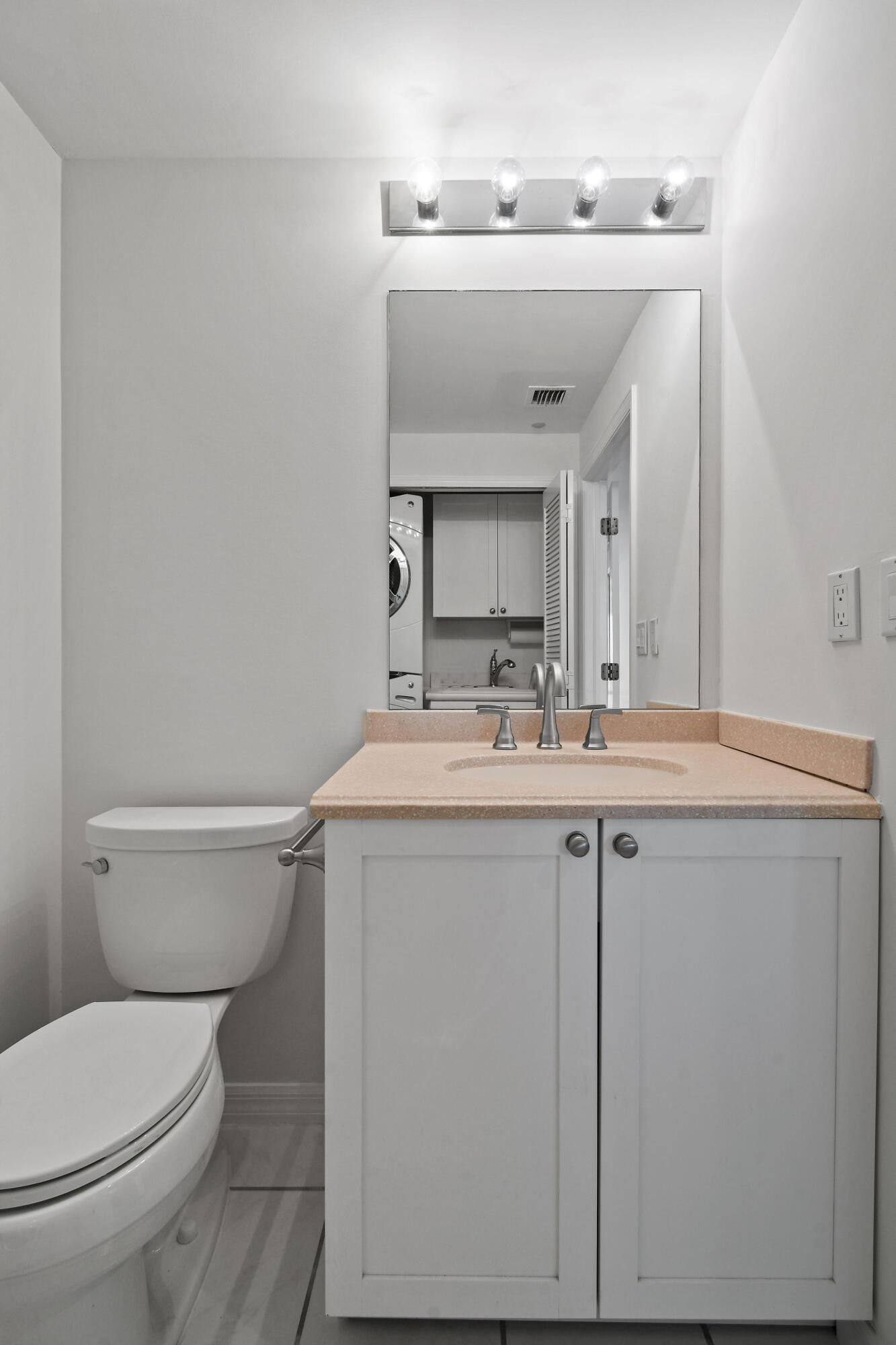 1660 Florida A1A, Unit 352 Jupiter, FL 33477 - Photo 28 of 36 a bathroom with a toilet sink and mirror