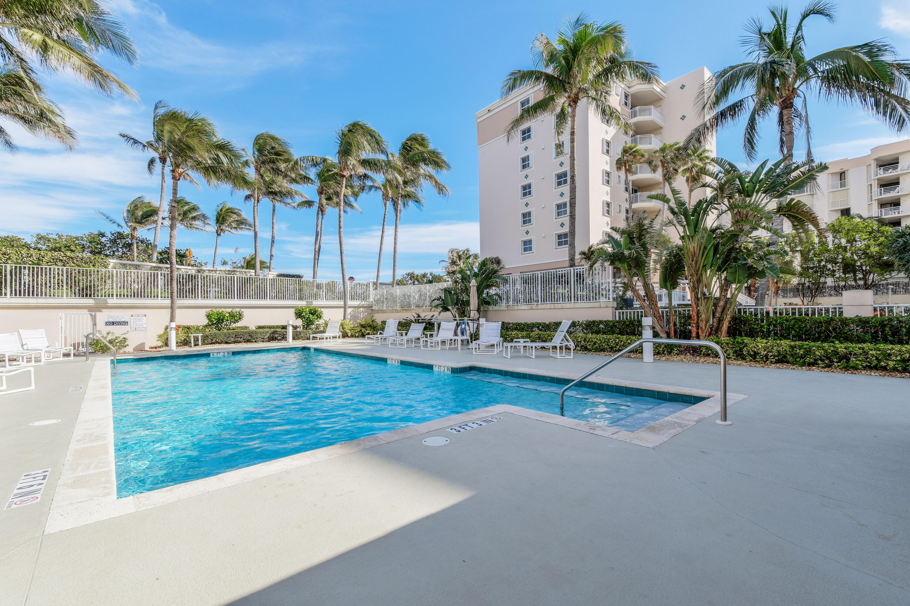 1660 Florida A1A, Unit 352 Jupiter, FL 33477 - Photo 30 of 36 a view of swimming pool with outdoor seating and a palm tree