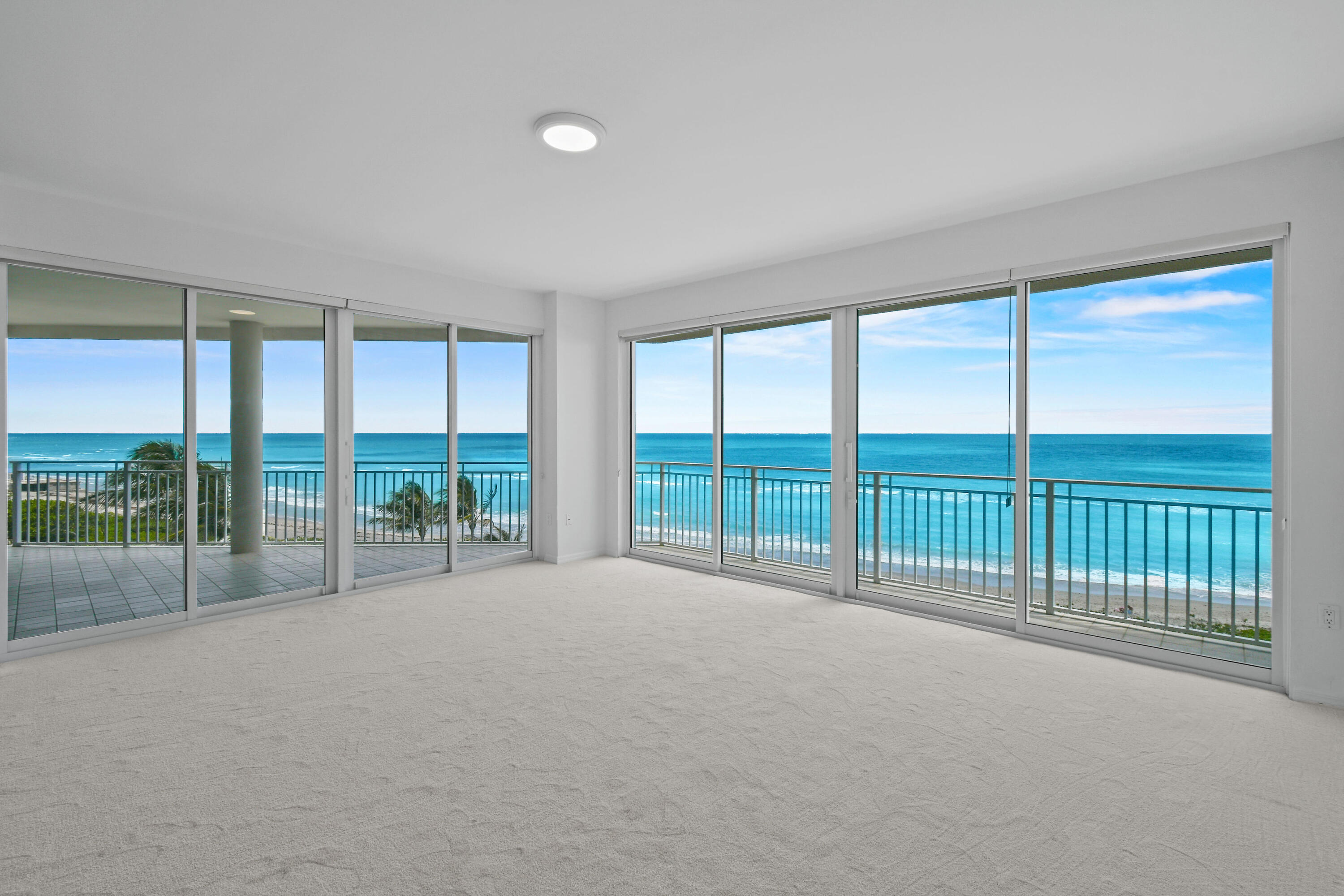 1660 Florida A1A, Unit 352 Jupiter, FL 33477 - Photo 3 of 36 a view of an empty room with wooden floor and glass door