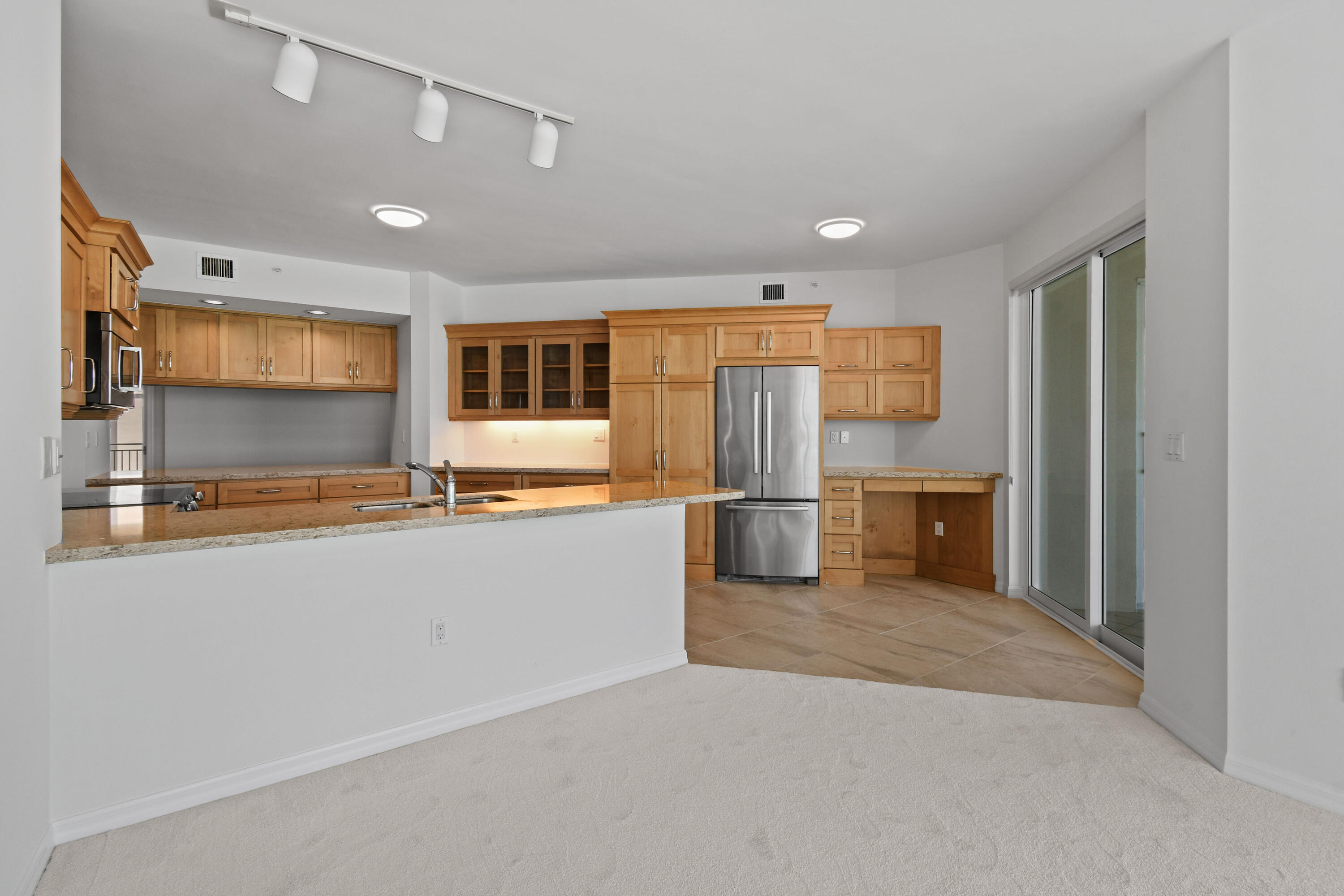 1660 Florida A1A, Unit 352 Jupiter, FL 33477 - Photo 6 of 36 a kitchen with stainless steel appliances granite countertop a refrigerator a sink a stove and oven