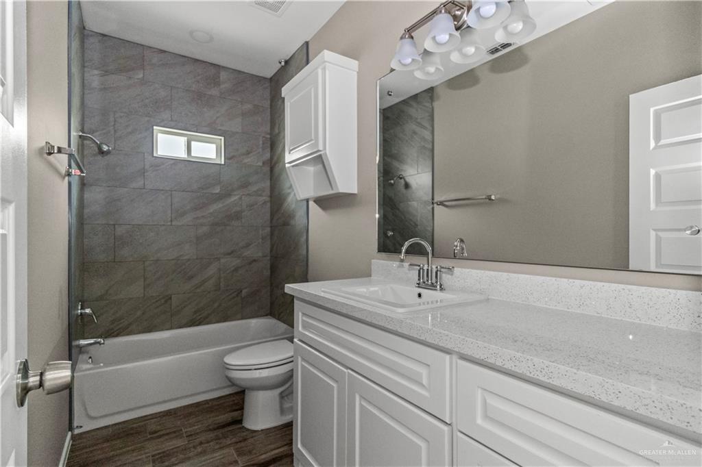 1314 Beverly Avenue, Unit 2 Weslaco, TX 78596 - Photo 11 of 11 Full bathroom featuring tiled shower / bath, oversized vanity, and toilet