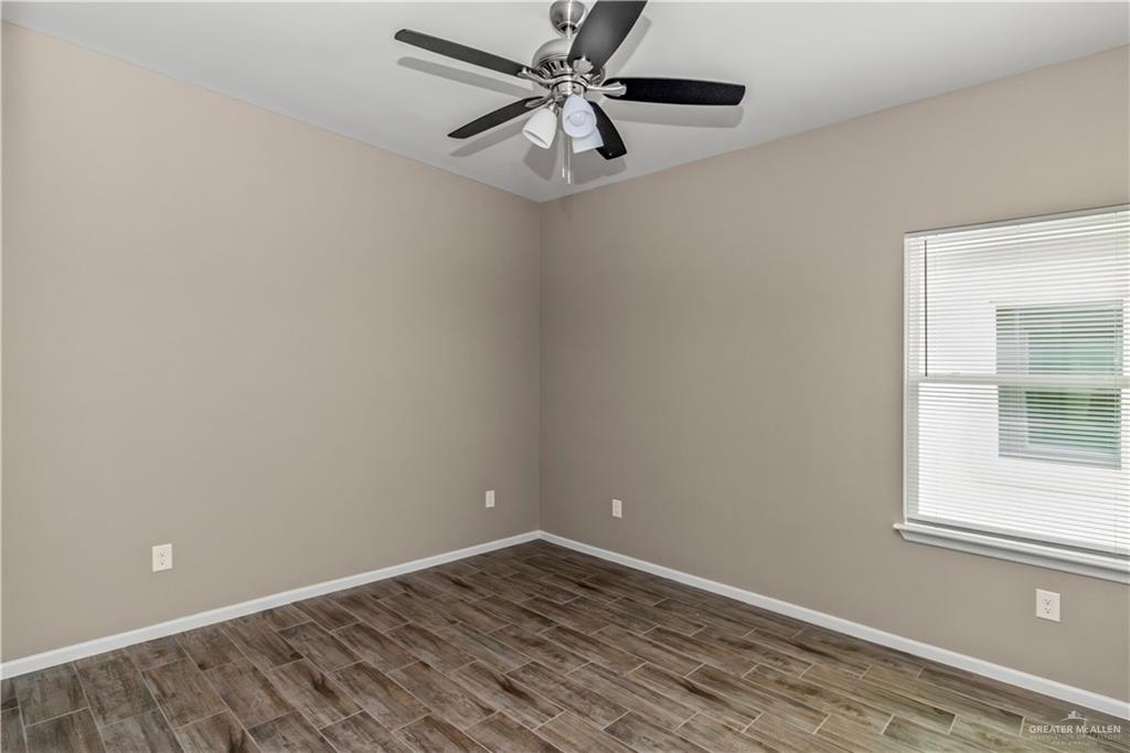 1314 Beverly Avenue, Unit 2 Weslaco, TX 78596 - Photo 10 of 11 Unfurnished room featuring ceiling fan and hardwood / wood-style flooring