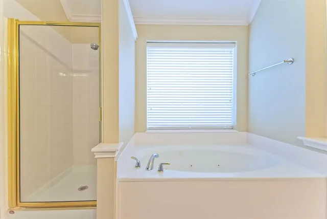 a white bath tub sitting next to a window