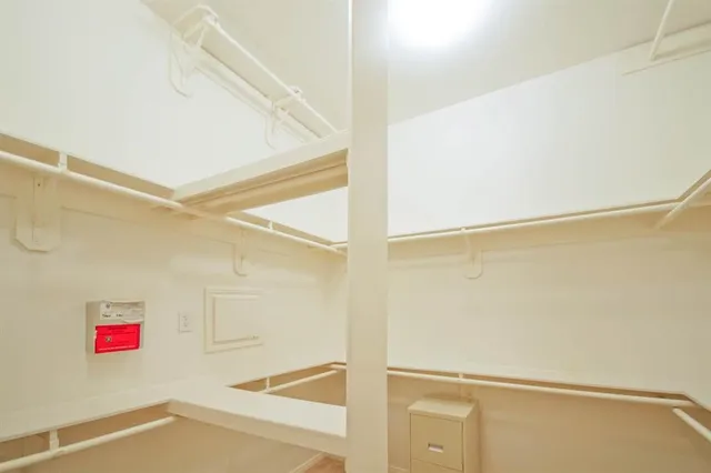 a view of walk in closet with empty racks