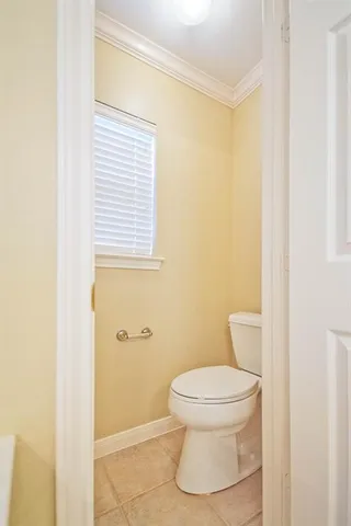 a white toilet sitting next to a bathroom sink