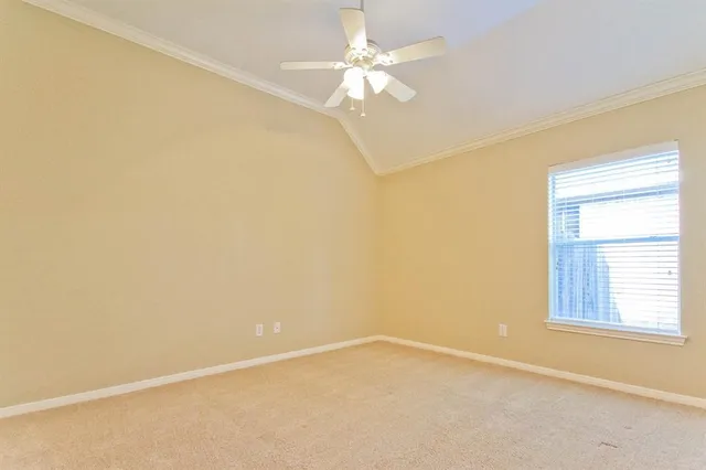 an empty room with a window and a ceiling fan