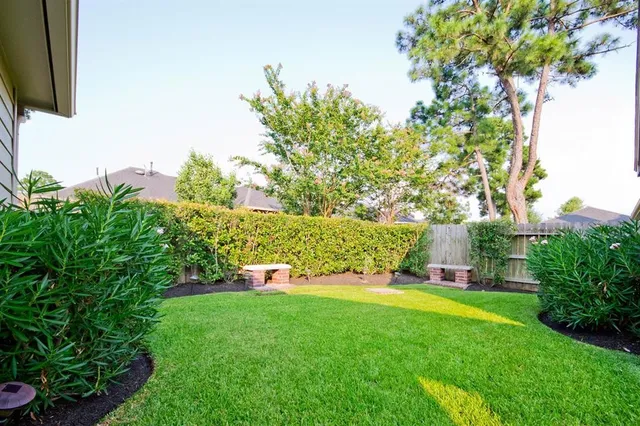a view of yard with swimming pool and green space