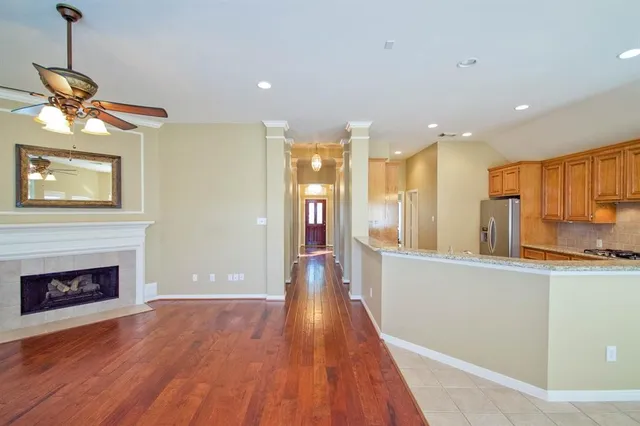 a view of a kitchen with a sink wooden floor and a living room