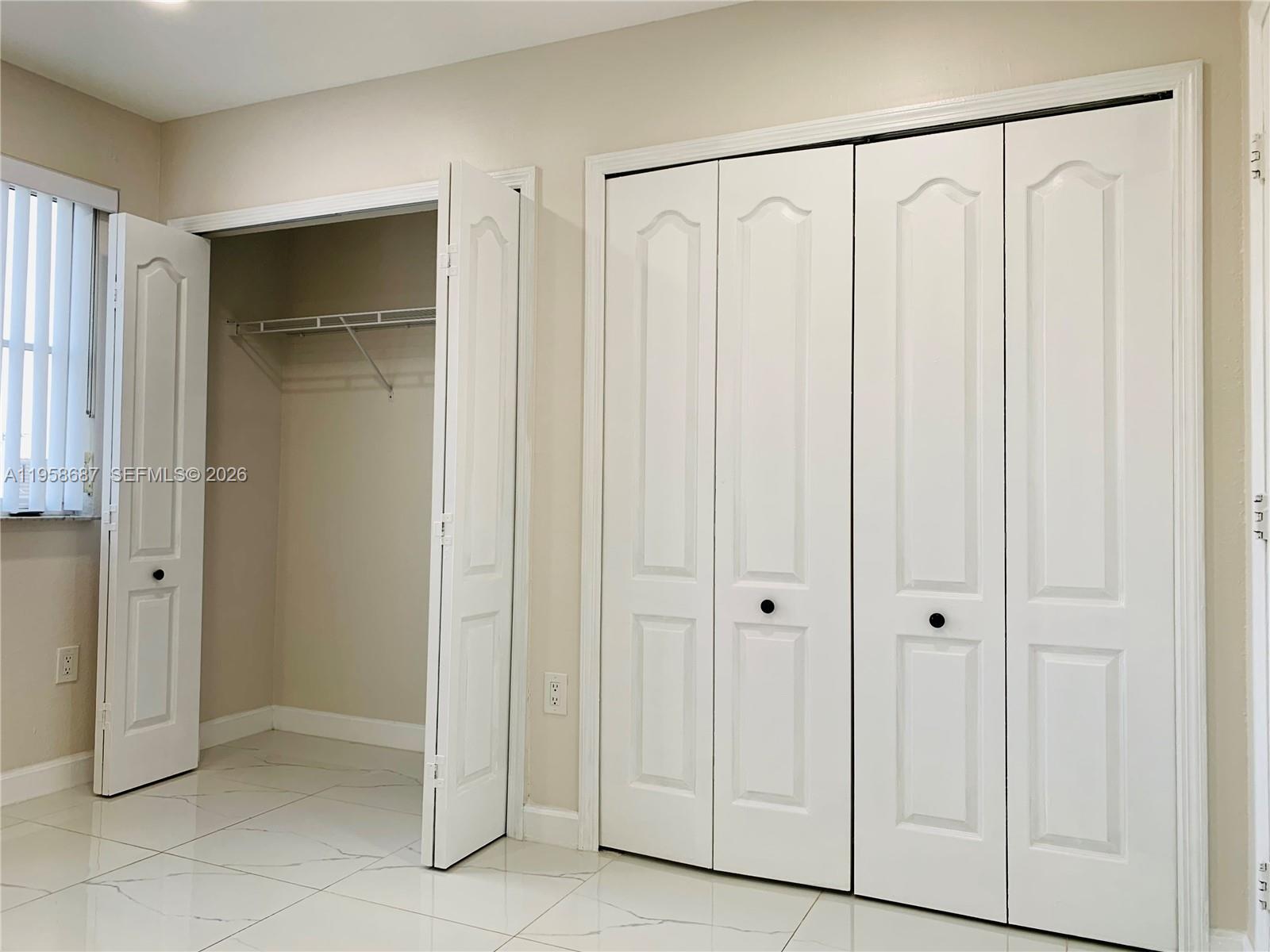 7250 Northwest 177th Street, Unit 208 Hialeah, FL 33015 - Photo 11 of 13 a view of a hallway with white doors