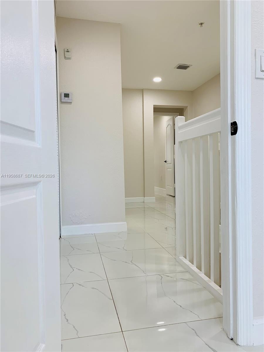 7250 Northwest 177th Street, Unit 208 Hialeah, FL 33015 - Photo 12 of 13 a view of a hallway