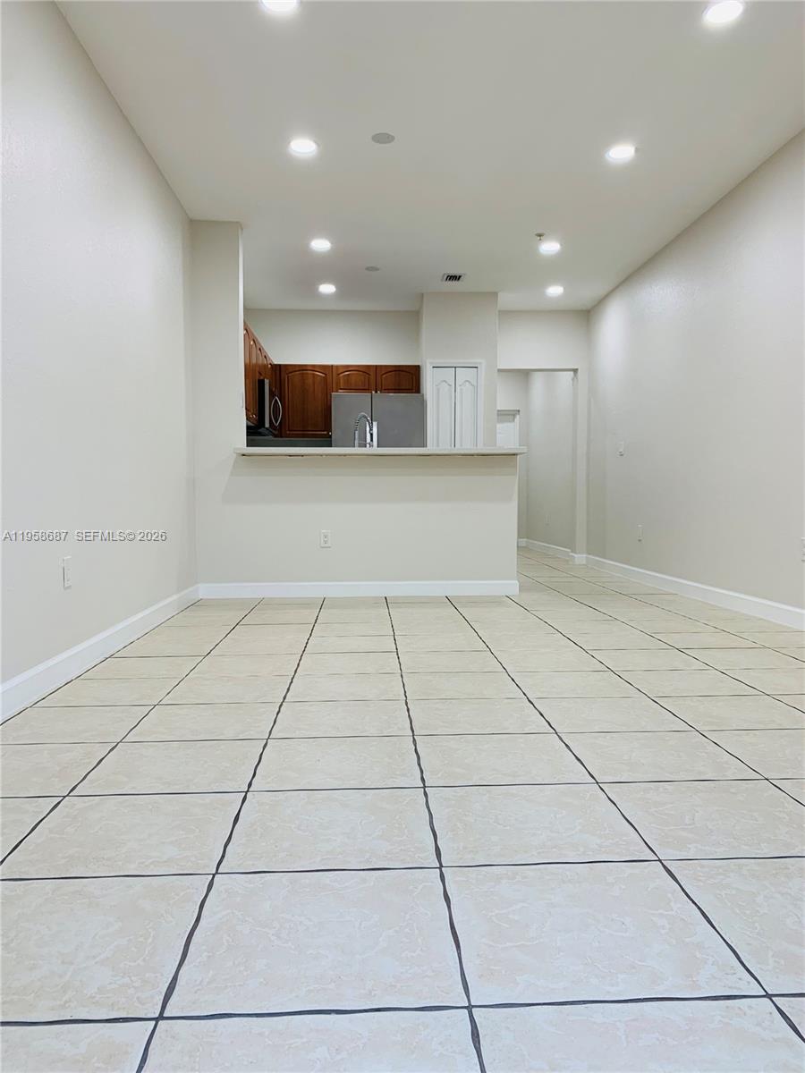 7250 Northwest 177th Street, Unit 208 Hialeah, FL 33015 - Photo 5 of 13 a view of an empty room with a window