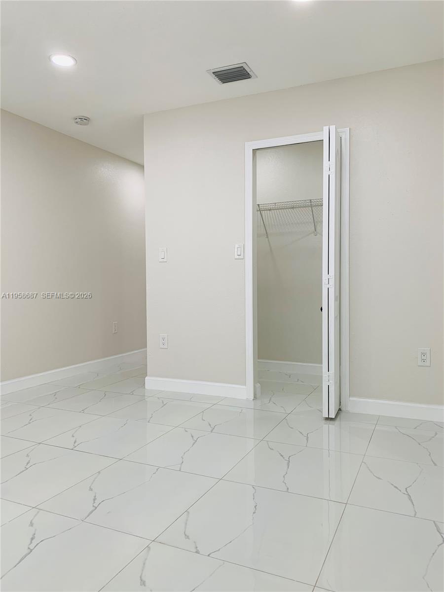 7250 Northwest 177th Street, Unit 208 Hialeah, FL 33015 - Photo 7 of 13 an empty room with white walls