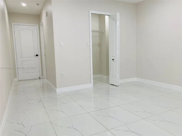 a bathroom with a toilet a sink a shower and a mirror