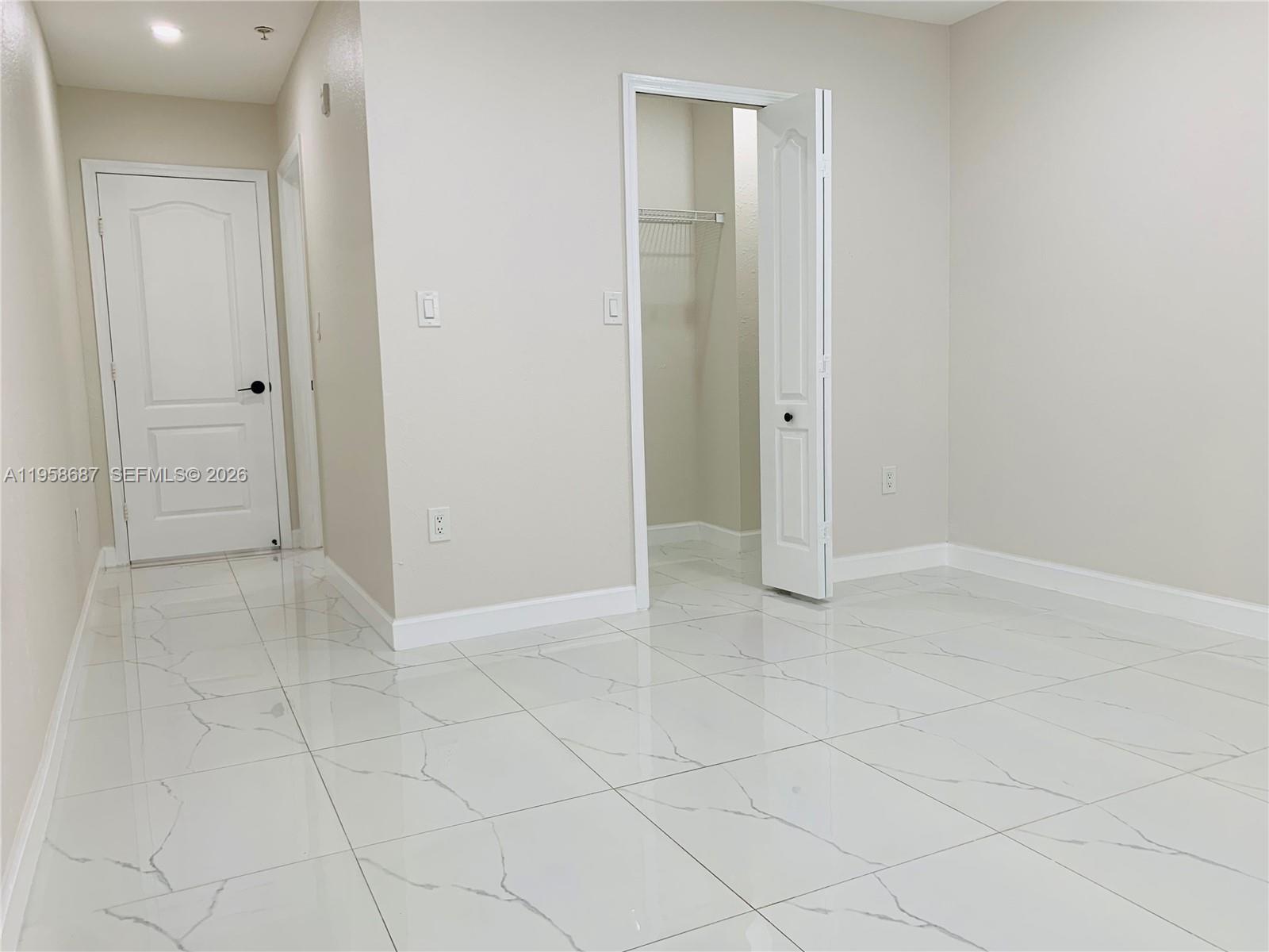 7250 Northwest 177th Street, Unit 208 Hialeah, FL 33015 - Photo 8 of 13 an empty room with white walls