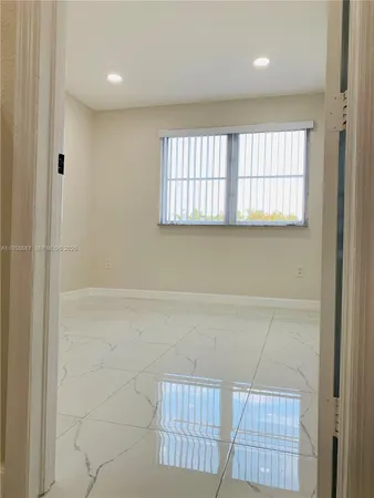 a view of a hallway with white doors