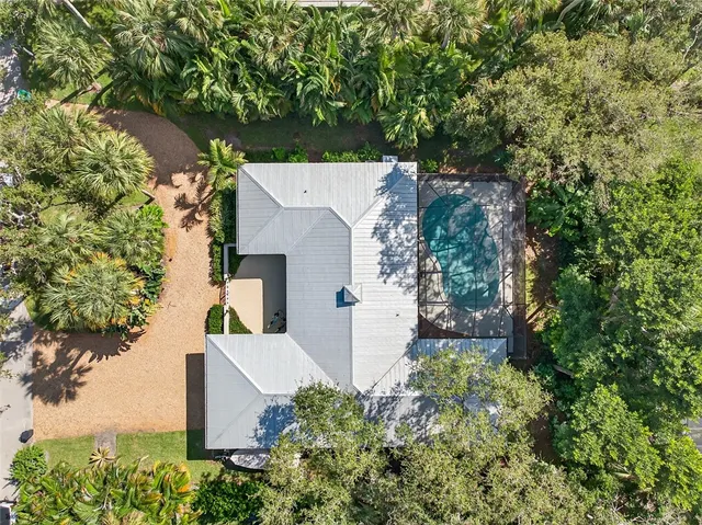an aerial view of a house with a yard