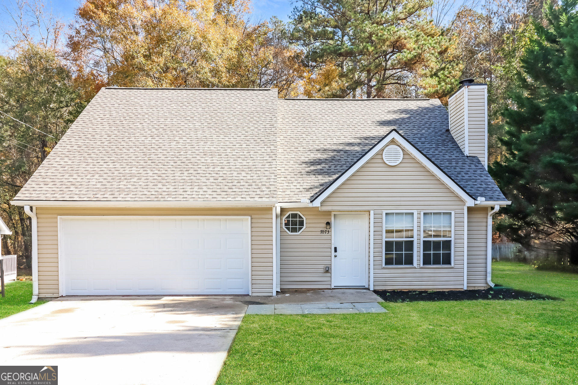 front view of a house with a yard