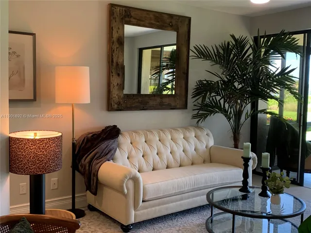 a living room with furniture and a lamp