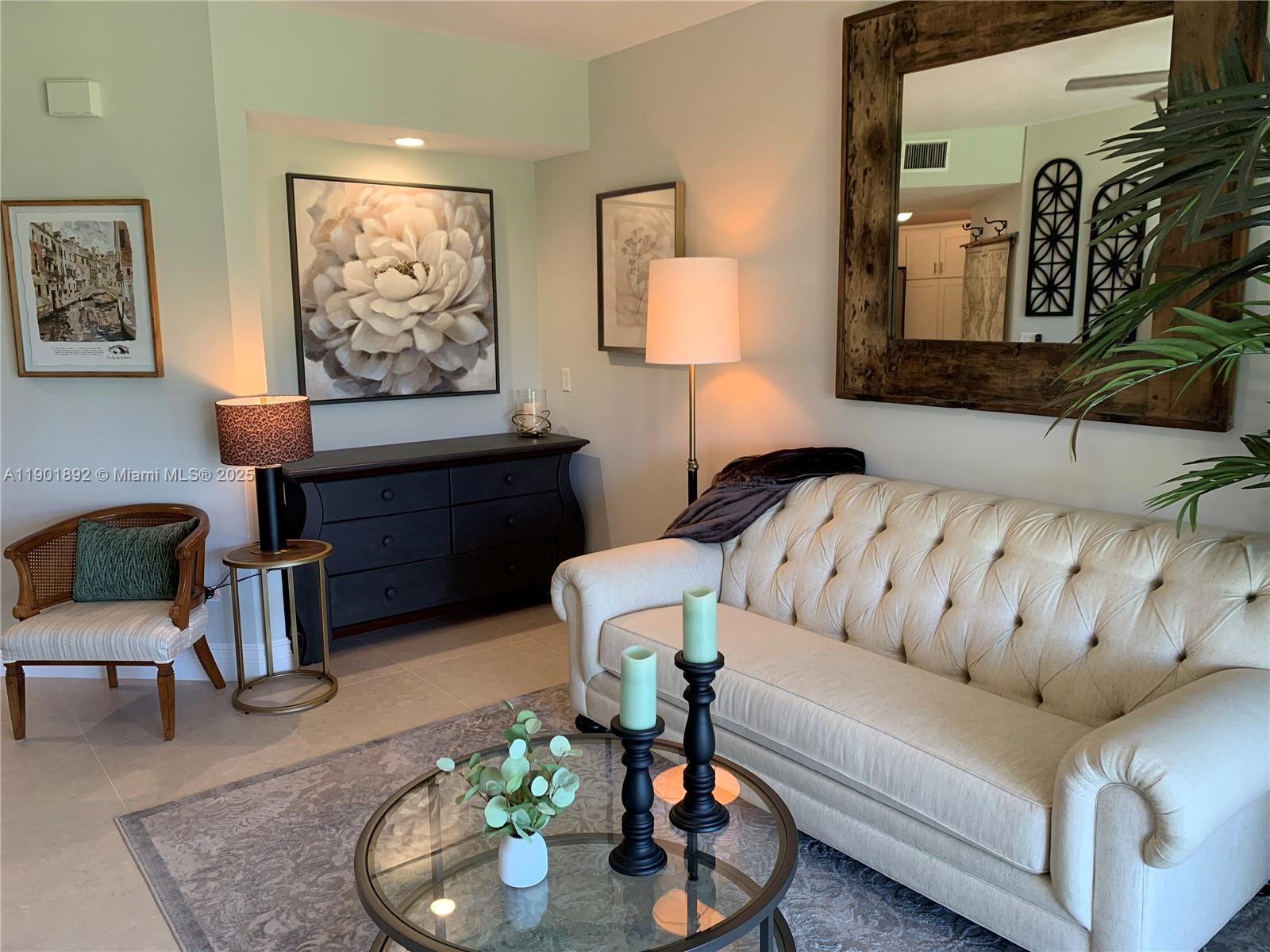 6102 Southeast Landing Way, Unit 2 Stuart, FL 34997 - Photo 21 of 51 a living room with furniture and a lamp