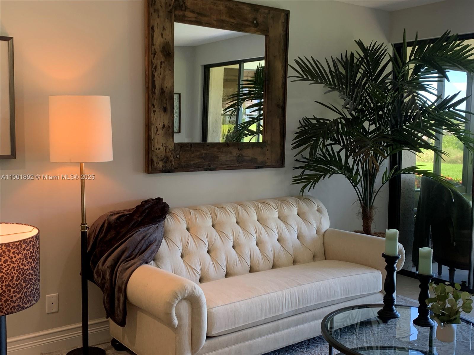6102 Southeast Landing Way, Unit 2 Stuart, FL 34997 - Photo 22 of 51 a living room with furniture and a potted plant